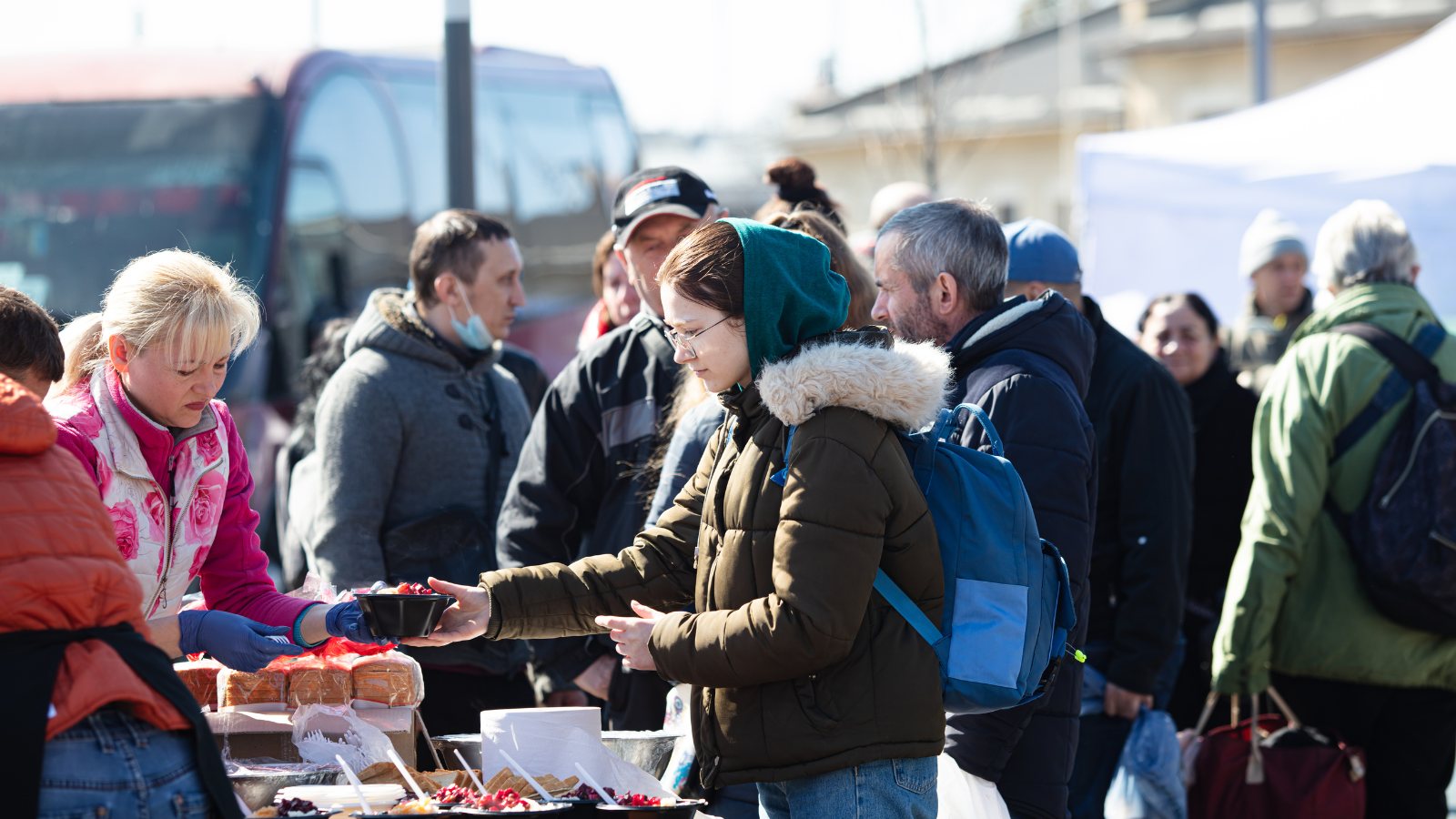 People lining up together at a community food table
