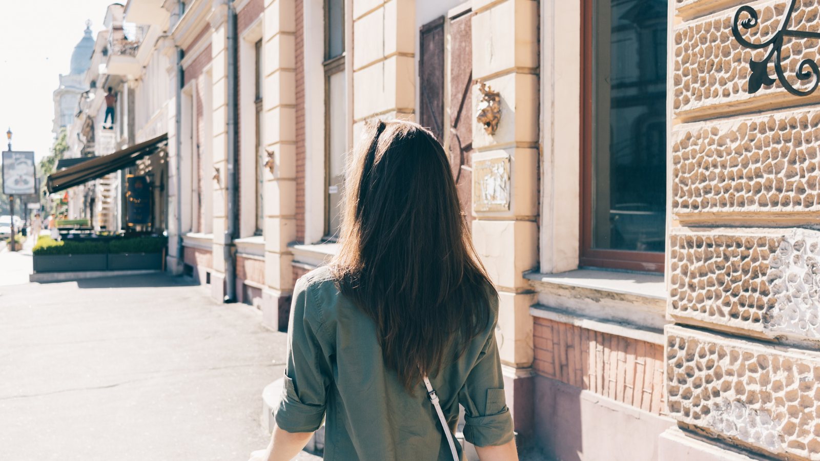 Someone walking a city street, seen from behind